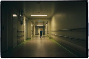 Child standing in dark hallway