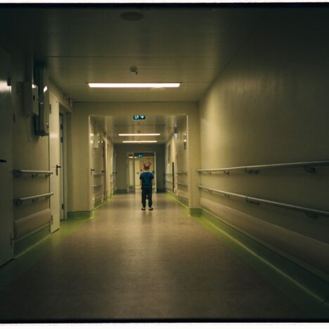 Child standing in dark hallway