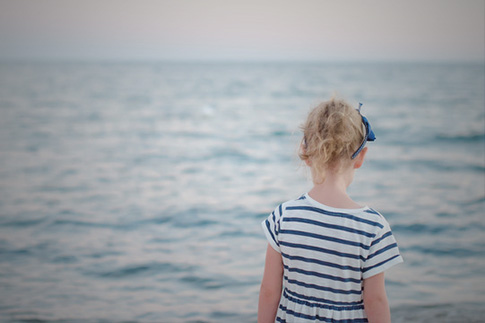 child walking on beach alone