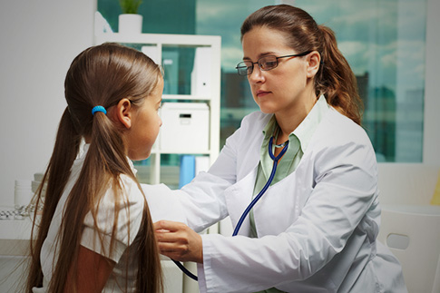 doctor examining child heartbeat
