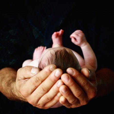 Newborn in fathers hands